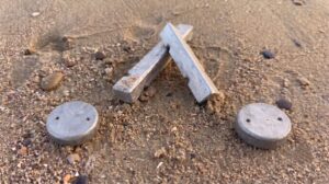 Shrimp and crab pot weights on a beach